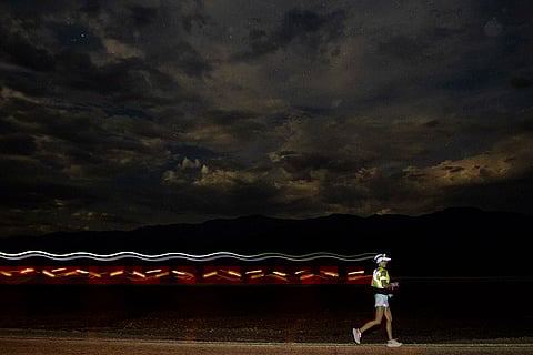 A runner races with a headlamp
